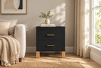 Fluted black nightstand in a styled modern room, wider view