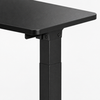 Electric Standing Desk, Height-Adjustable – Black — close-up detail of frame and desktop edge